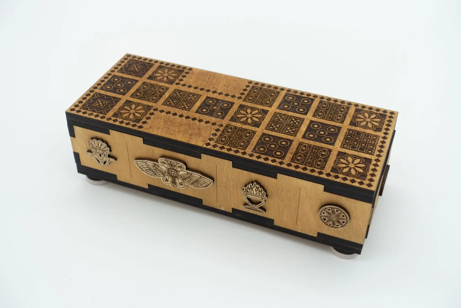 The Ancient Origins Royal Game of Ur: a honey-colored wooden box with the twenty-square board engraved on the lid and pale wood medallions along the side.