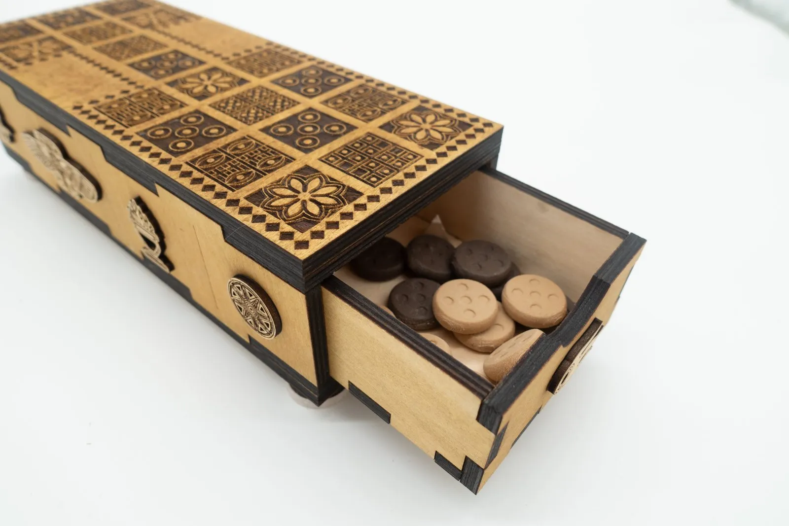 The drawer in the Ancient Origins Royal Game of Ur pulled open, with the round playing pieces stored inside.
